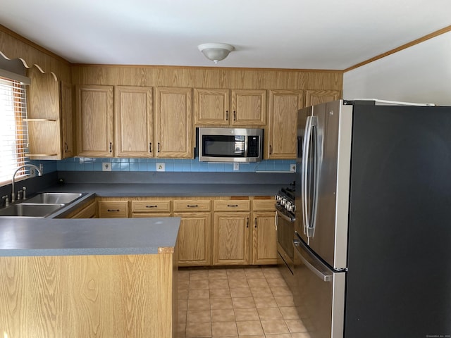 41 Wilshire Blvd, Milford, CT 06460 - kitchen featuring light tile patterned floors, stainless steel appliances, a sink, a peninsula, and light brown cabinets