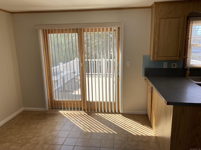 41 Wilshire Blvd, Milford, CT 06460 - kitchen with baseboards, ornamental molding, dark countertops, and light tile patterned floors