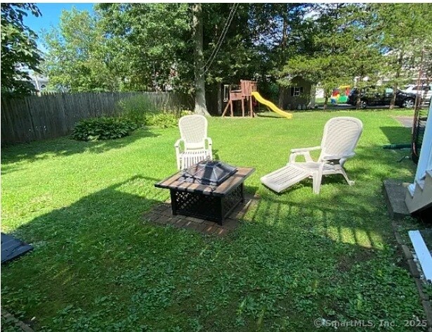 41 Wilshire Blvd, Milford, CT 06460 - view of yard with a playground, a fire pit, and fence