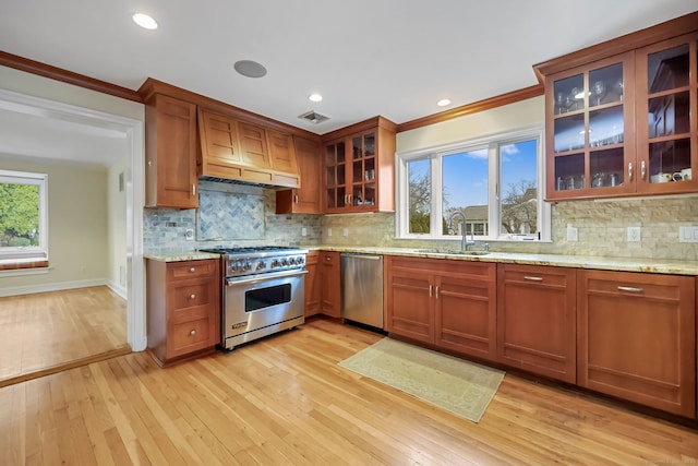 9 Pine Hill Avenue Ext, Norwalk, CT 06855 - kitchen featuring light wood-style flooring, ornamental molding, appliances with stainless steel finishes, light stone counters, and a sink