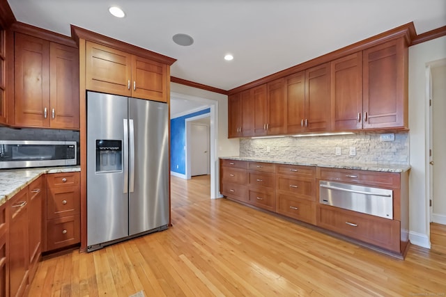 9 Pine Hill Avenue Ext, Norwalk, CT 06855 - kitchen with baseboards, light stone counters, a warming drawer, stainless steel appliances, and light wood finished floors
