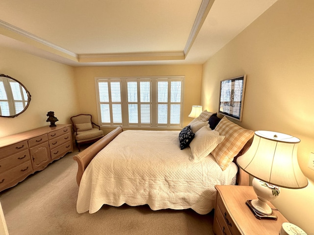 bedroom featuring a tray ceiling, crown molding, and light carpet