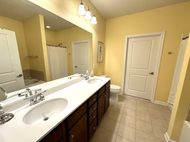 bathroom with baseboards, tile patterned floors, a sink, and double vanity