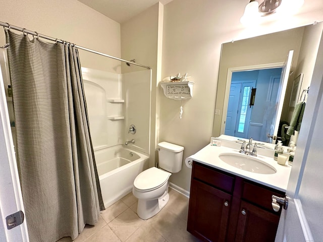 full bath with tile patterned flooring, toilet, vanity, shower / tub combo with curtain, and baseboards