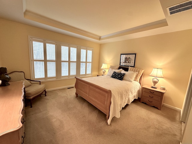 bedroom featuring a tray ceiling, visible vents, light colored carpet, and ornamental molding