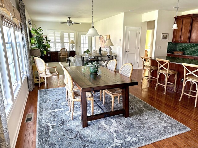 dining area with ceiling fan, dark wood-style flooring, and visible vents