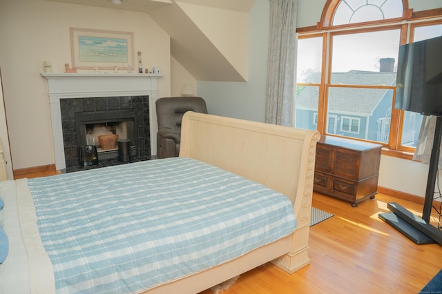 78 Limewood Ave, Branford, CT 06405 - bedroom with wood finished floors, a tile fireplace, and baseboards