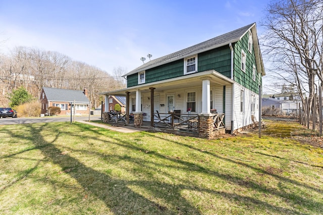 view of front of house with covered porch and a front yard