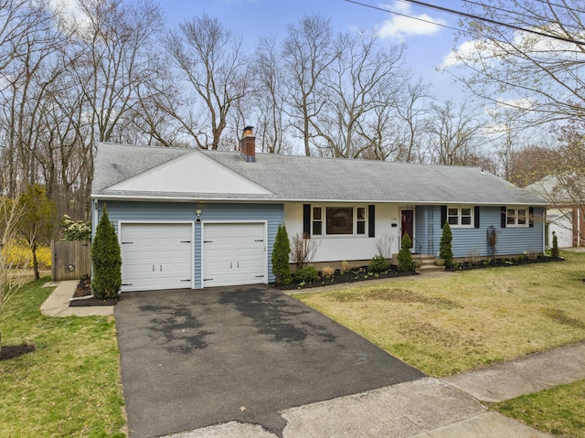 single story home featuring a chimney, driveway, a front yard, a garage, and a shingled roof
