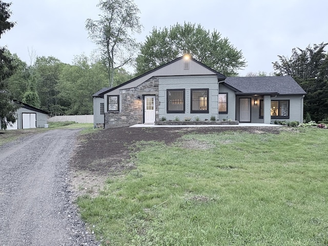 220 W Rd, Colchester, CT 06415 - modern farmhouse style home with an outdoor structure, driveway, a front yard, stone siding, and a shed