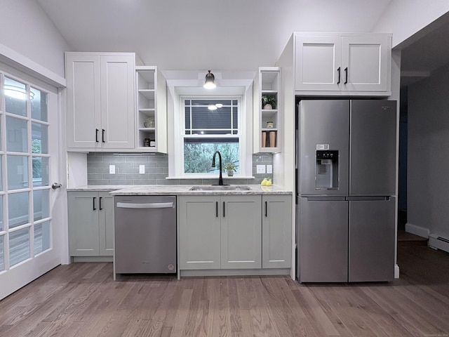 220 W Rd, Colchester, CT 06415 - kitchen featuring stainless steel appliances, open shelves, a sink, light wood-style flooring, and tasteful backsplash