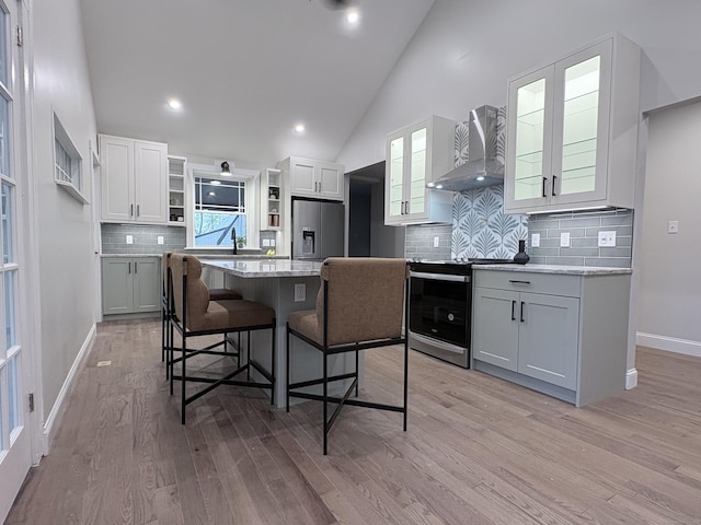 220 W Rd, Colchester, CT 06415 - kitchen featuring wall chimney exhaust hood, stainless steel appliances, a kitchen bar, open shelves, and a kitchen island