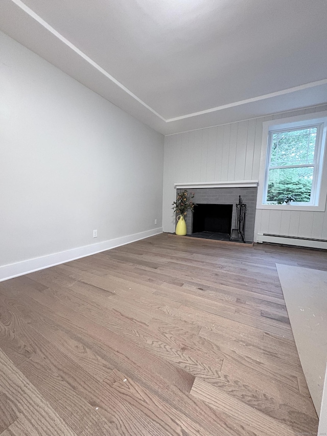 220 W Rd, Colchester, CT 06415 - unfurnished living room featuring baseboard heating, wood finished floors, a fireplace, and baseboards