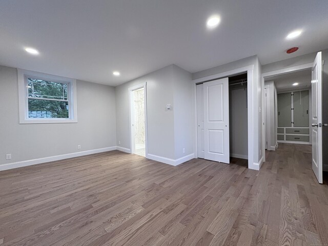 220 W Rd, Colchester, CT 06415 - unfurnished bedroom featuring wood finished floors, baseboards, recessed lighting, and a closet