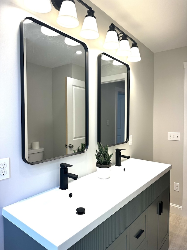 220 W Rd, Colchester, CT 06415 - bathroom with double vanity, wood finished floors, and baseboards