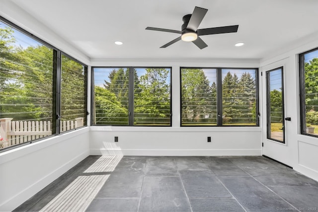 unfurnished sunroom featuring ceiling fan