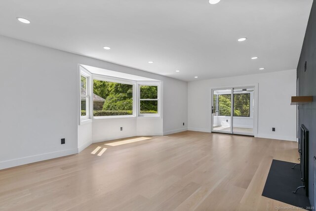 32 Pine Hill Ave, Norwalk, CT 06855 - unfurnished living room with light wood-style flooring, baseboards, recessed lighting, and a fireplace