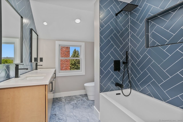 full bathroom featuring a tub, toilet, double vanity, a shower, and baseboards