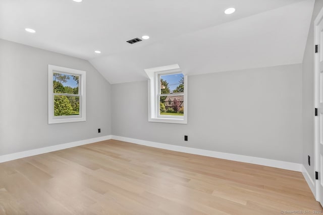 bonus room featuring vaulted ceiling, baseboards, light wood finished floors, and recessed lighting