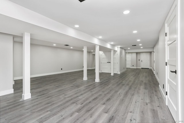 finished basement with baseboards, light wood-style floors, and recessed lighting
