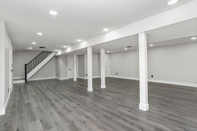 finished basement featuring wood finished floors, baseboards, stairway, and recessed lighting