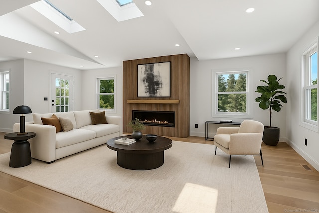 32 Pine Hill Ave, Norwalk, CT 06855 - living room featuring light wood-style floors, recessed lighting, a large fireplace, a skylight, and vaulted ceiling