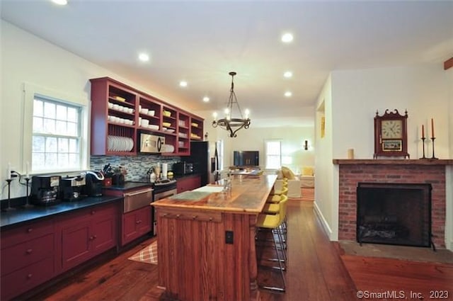 33 Sentry Hill Rd, Roxbury, CT 06783 - kitchen featuring a fireplace, tasteful backsplash, dark wood finished floors, open floor plan, and stainless steel appliances