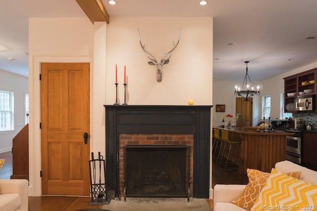 33 Sentry Hill Rd, Roxbury, CT 06783 - living area with wood finished floors, a chandelier, recessed lighting, and a brick fireplace