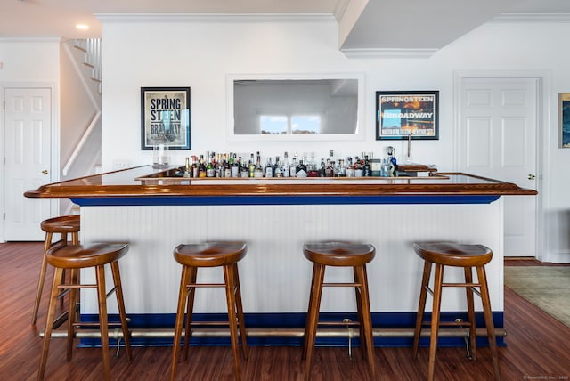 38 Yarmouth Rd, Norwalk, CT 06853 - indoor wet bar with crown molding, dark wood-style floors, and stairs