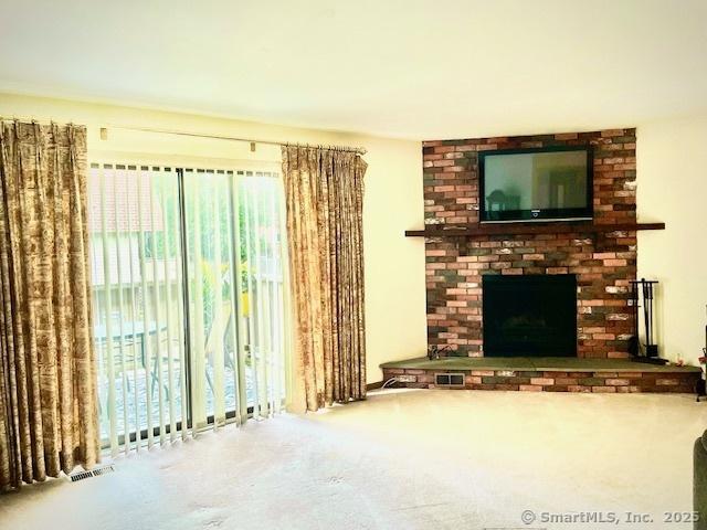 202 Soundview Ave Unit 3, Stamford, CT 06902 - unfurnished living room with carpet and a fireplace