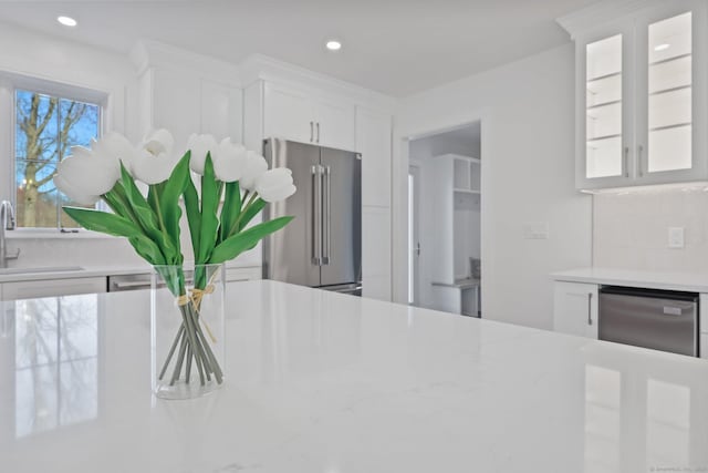 71 Reid St, Fairfield, CT 06824 - kitchen view of stainless steel appliances, a sink, white cabinetry, glass insert cabinets, and recessed lighting