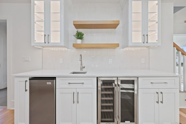 71 Reid St, Fairfield, CT 06824 - indoor wet bar featuring wine cooler, freestanding refrigerator, and backsplash