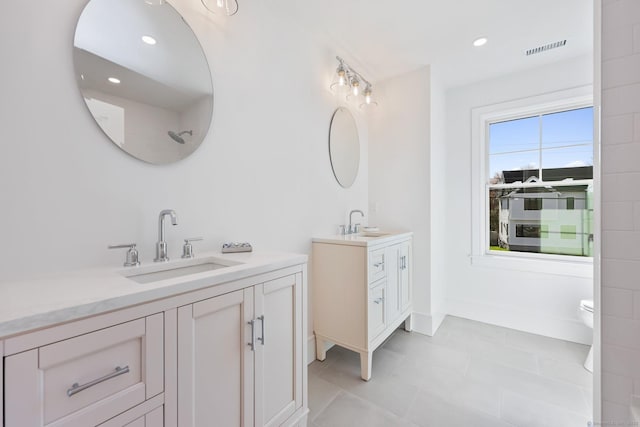71 Reid St, Fairfield, CT 06824 - full bathroom featuring two vanities, tile patterned floors, and recessed lighting