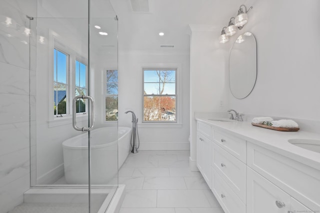 71 Reid St, Fairfield, CT 06824 - full bath with marble look tile flooring, double vanity, a freestanding tub, recessed lighting, and a shower with shower door