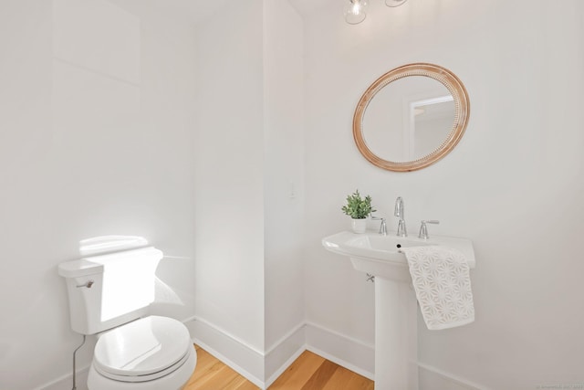 71 Reid St, Fairfield, CT 06824 - half bathroom featuring wood finished floors, toilet, and baseboards