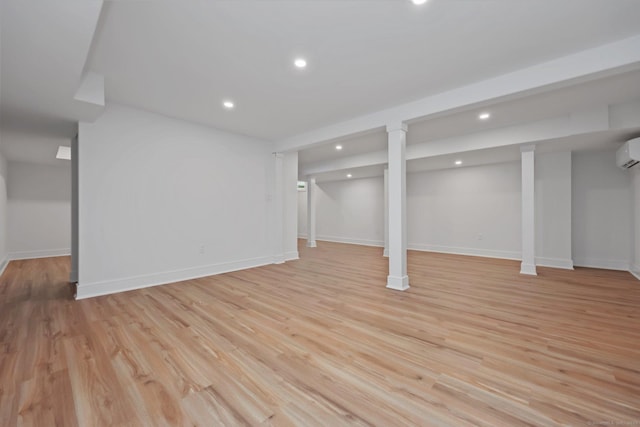 71 Reid St, Fairfield, CT 06824 - finished below grade area featuring a wall mounted air conditioner, recessed lighting, baseboards, and light wood-type flooring