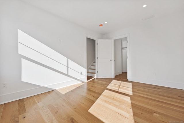 71 Reid St, Fairfield, CT 06824 - spare room with baseboards, recessed lighting, wood finished floors, and stairs