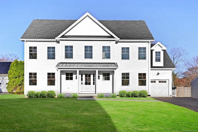 71 Reid St, Fairfield, CT 06824 - view of front facade featuring a standing seam roof, a front yard, metal roof, driveway, and roof with shingles