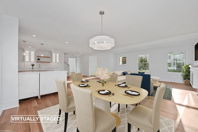 71 Reid St, Fairfield, CT 06824 - dining room with light wood-style flooring, recessed lighting, stairway, and baseboards
