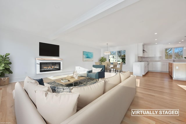 71 Reid St, Fairfield, CT 06824 - living room with a glass covered fireplace, light wood-type flooring, beam ceiling, and recessed lighting
