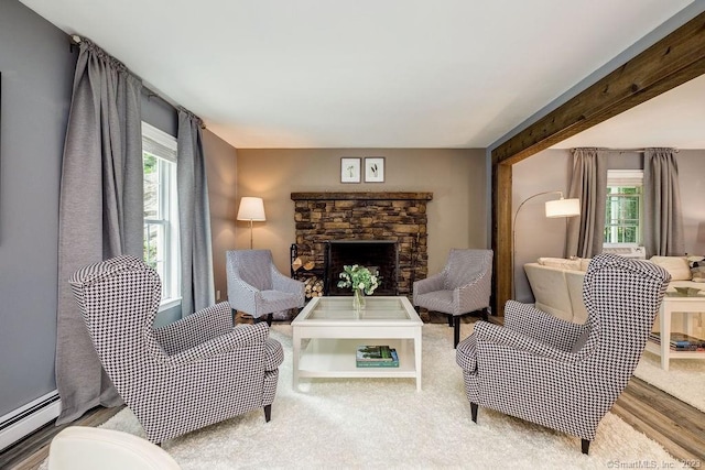 18 Tunnel Rd, Roxbury, CT 06783 - living area with a baseboard heating unit, a fireplace, and wood finished floors