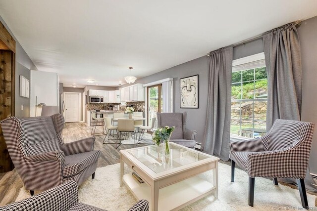 18 Tunnel Rd, Roxbury, CT 06783 - living area featuring healthy amount of natural light, light wood-type flooring, and a chandelier