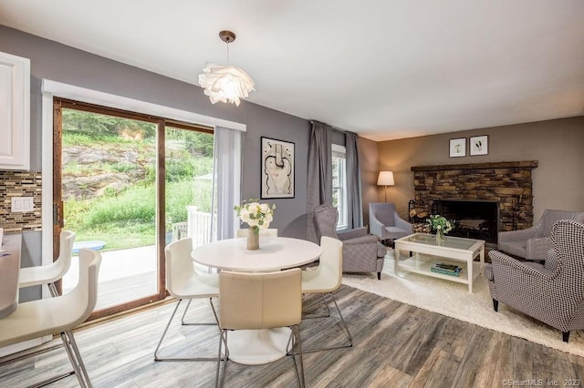 18 Tunnel Rd, Roxbury, CT 06783 - dining room with light wood-type flooring and a stone fireplace
