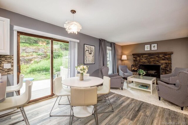 18 Tunnel Rd, Roxbury, CT 06783 - dining space with light wood-type flooring and a stone fireplace