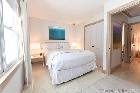 bedroom with baseboards and a closet