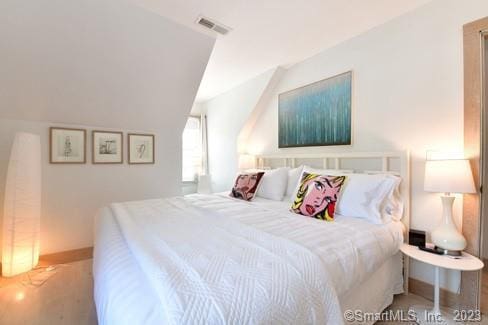 bedroom with baseboards and visible vents
