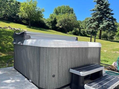 exterior space featuring a hot tub