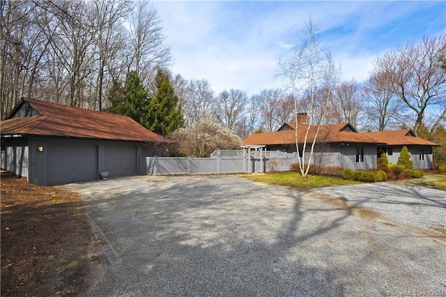 247 Painter Hill Rd, Roxbury, CT 06783 - view of side of home with a chimney, a garage, and an outbuilding