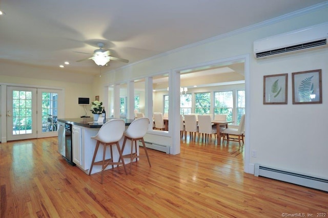 45 Moosehorn Rd, Roxbury, CT 06783 - kitchen with a wall mounted AC, a breakfast bar area, light wood-type flooring, and ornamental molding