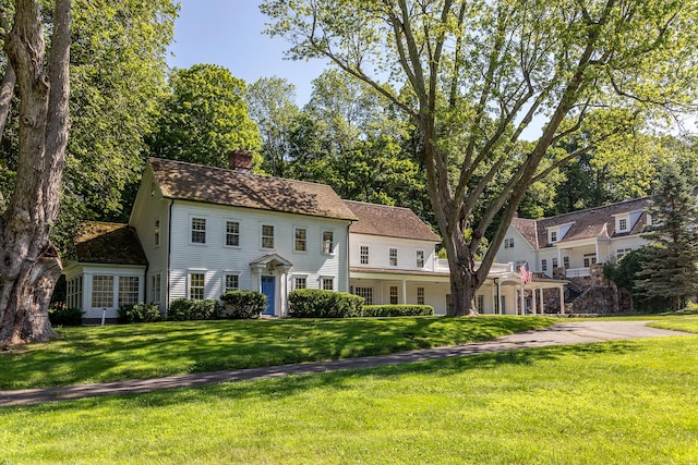 10 Sunny Ridge Rd, Washington, CT 06793 - colonial home featuring a chimney, a front lawn, and roof with shingles